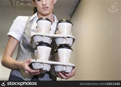 Woman carrying coffee cups