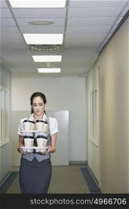 Woman carrying coffee cups