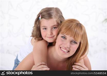 Woman carrying daughter on back