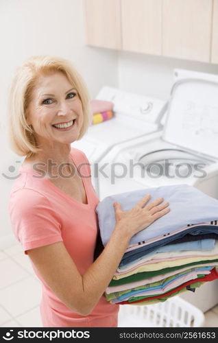 Woman Carrying Folded Up Laundry