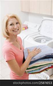 Woman Carrying Folded Up Laundry