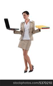 Woman carrying laptop and folders