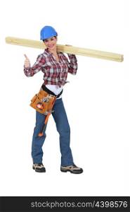 Woman carrying two planks of wood