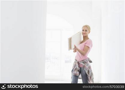 Woman carrying wooden planks on shoulder