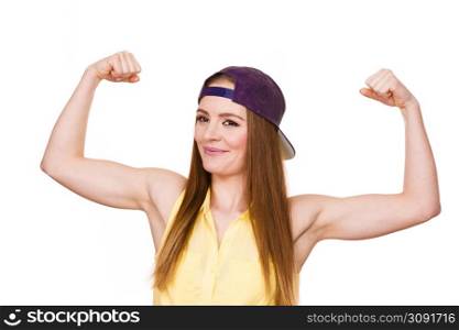 Woman casual style teen girl cap on head showing off muscles biceps. Youth style. Power and strength concept. Studio shot isolated on white. Woman casual style showing off muscles biceps