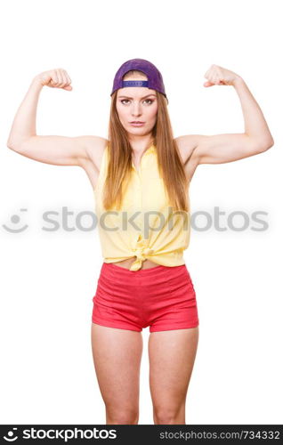 Woman casual style teen girl cap on head showing off muscles biceps. Youth style. Power and strength concept. Studio shot isolated on white. Woman casual style showing off muscles biceps