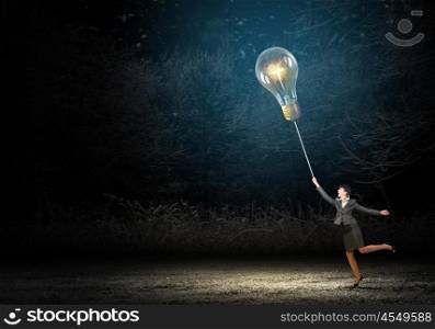 Woman catch bulb. Businesswoman in bowler hat pulling rope with glass light bulb