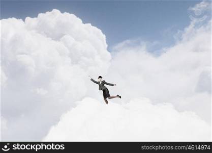 Woman catch cloud. Young businesswoman in bowler hat on cloud