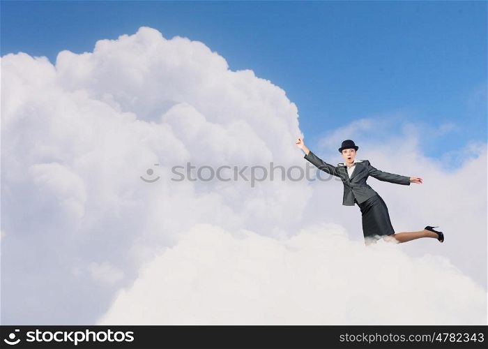 Woman catch cloud. Young businesswoman in bowler hat on cloud