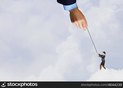 Woman catch cloud. Young businesswoman in bowler hat pulling rope