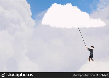 Woman catch cloud. Young businesswoman in bowler hat pulling white cloud with rope