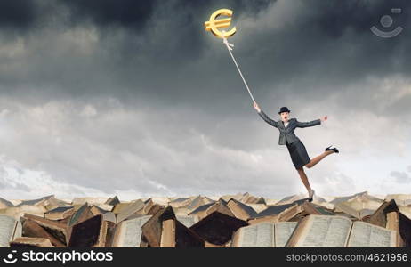 Woman catch euro. Young businesswoman in suit and bowler hat catching euro symbol