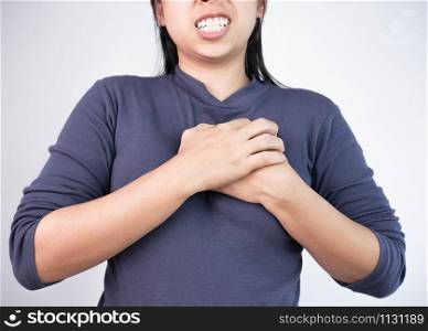 Woman catching on chest because she have pain from heart disease. Healthcare and medical concepts.