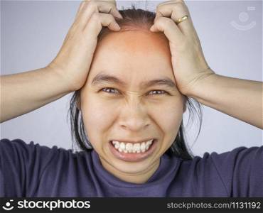Woman catching on head because she have acute headache. Healthcare and medical concepts.