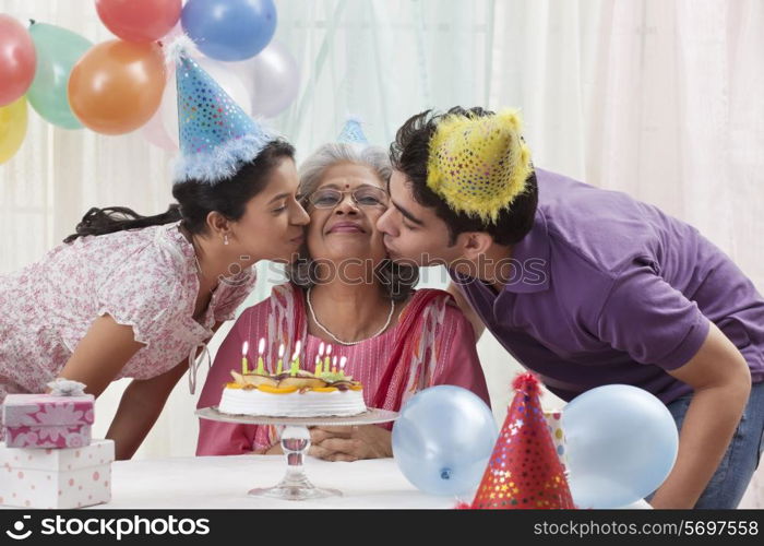 Woman celebrating birthday with grandchildren