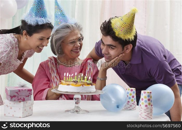 Woman celebrating birthday with grandchildren