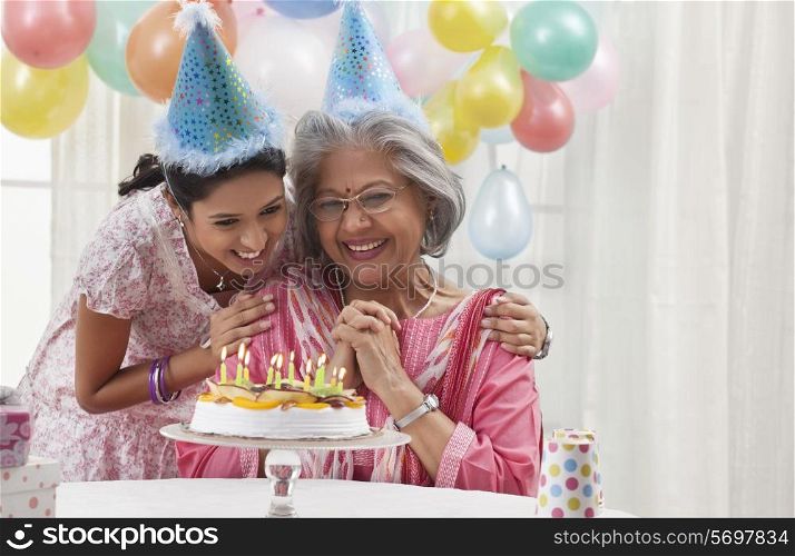Woman celebrating birthday with granddaughter