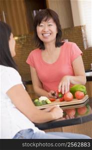 Woman Chatting To Friend While Preparing meal,mealtime