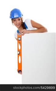 Woman checking a blank board is straight with a spirit level