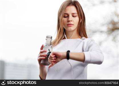 Woman checking fitness and health tracking wearable device.. Woman checking fitness and health tracking wearable device