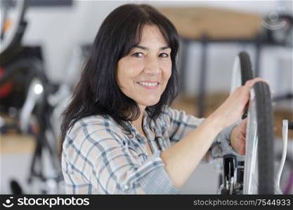 woman checking her bike at home