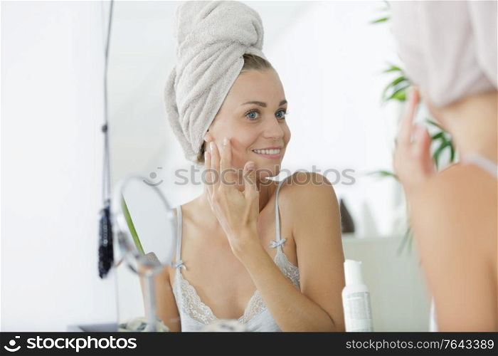 woman checking her complexion in the morning