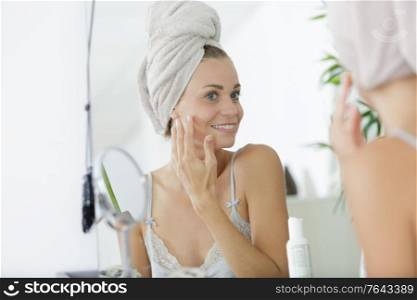 woman checking her complexion in the morning