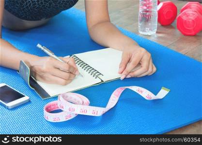 Woman checking her health after workout, Diet and Fitness concept