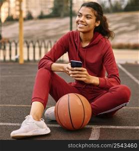 woman checking her phone basketball