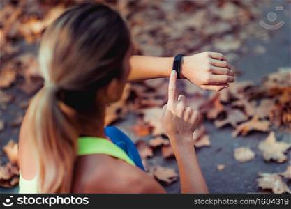 Woman Checking Progress on Smart Watch after Outdoor Training. Woman Looking at Smart Watch after Outdoor Training