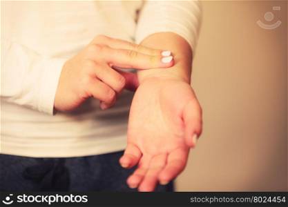 Woman checking pulse on wrist closeup. Medicine health care. Female hand checking pulse on wrist closeup.