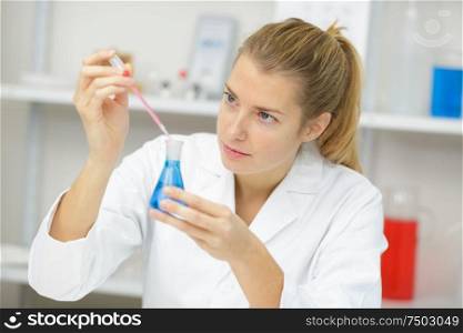woman chemist making a mixture