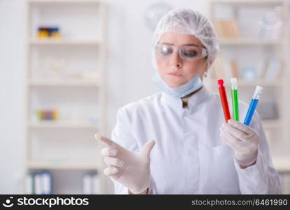 Woman chemist pressing virtual button in lab