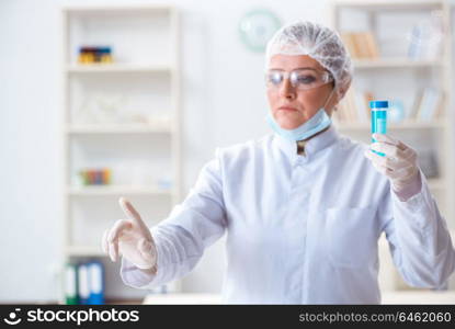 Woman chemist pressing virtual button in lab