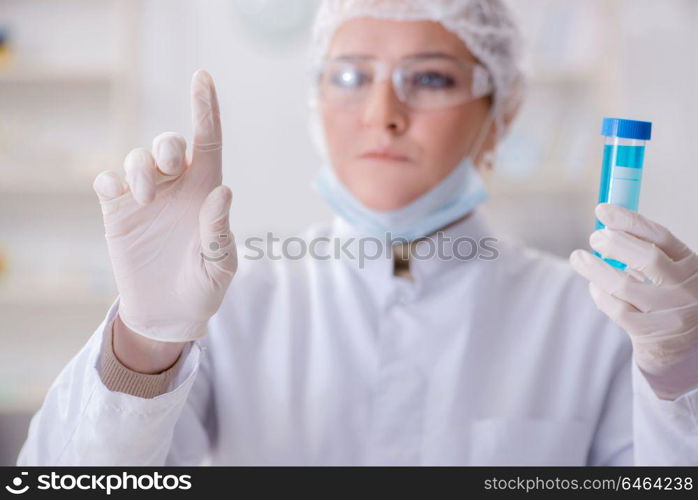 Woman chemist pressing virtual button in lab