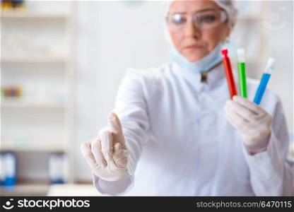Woman chemist pressing virtual button in lab