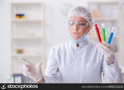 Woman chemist pressing virtual button in lab