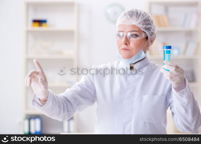 Woman chemist pressing virtual button in lab