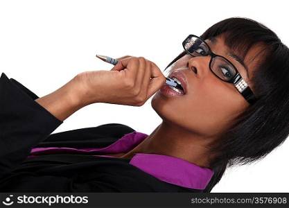 Woman chewing pen whilst thinking