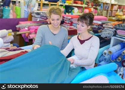 woman chooses scraps of colored tissue on table close up
