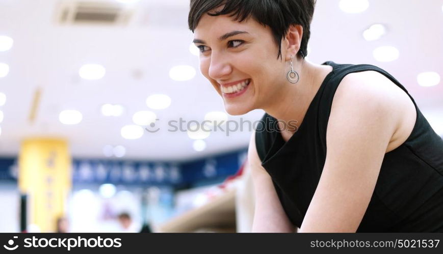 Woman Chooses Shoes At Fashionable Shop