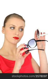 Woman choosing a pair of sunglasses