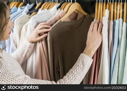 woman choosing dress during shopping garments apparel