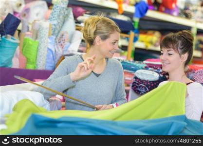woman choosing fabric at a textile wholesale store