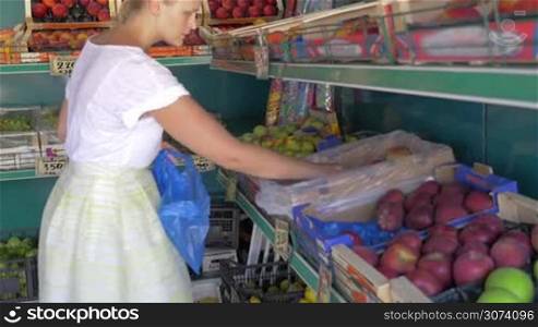 Woman choosing fruit in market