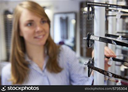 Woman Choosing Glasses In Opticians