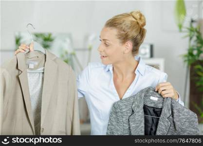 woman choosing jacket in boutique