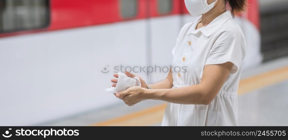 woman clean hand by wet wipe tissue in public transportation, protection Coronavirus disease (COVID-19 ) infection.safety travel and personal hygiene concepts