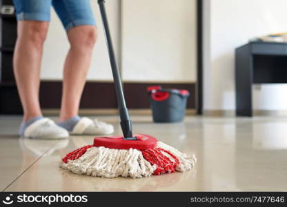 Woman Cleaning Floor with Mop