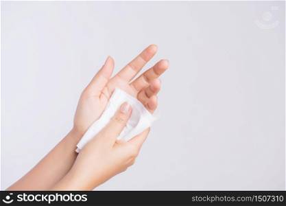 Woman cleaning her hands with a tissue. Healthcare and medical concept.